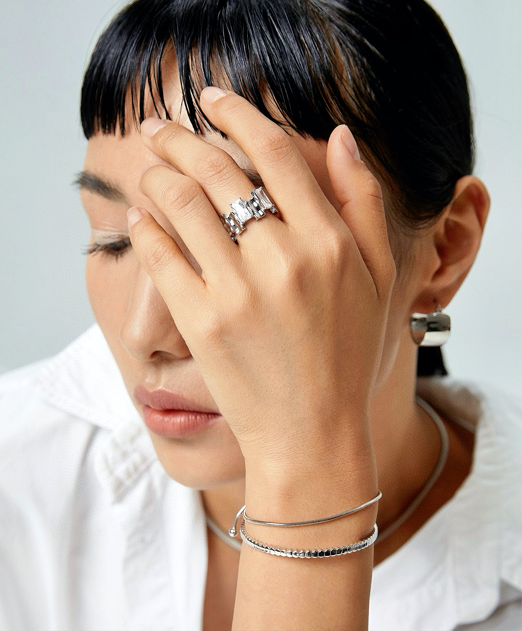 Ring with irregular rectangular spaced zircon design